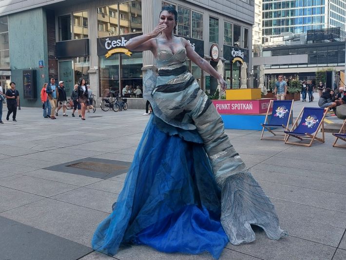 Living statue dressed as a mermaid in blue costume
