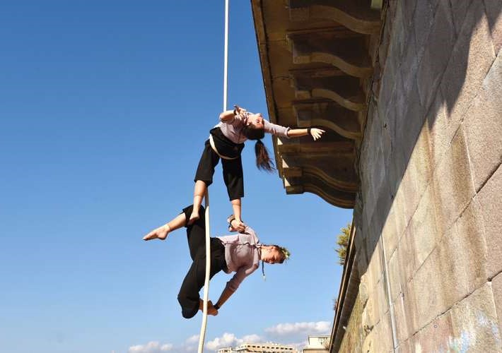 Two women on a rope doing aerial acrobatics